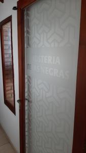 a door with a sign that reads ética tas nerebris at Hostería Tejas Negras in Mina Clavero