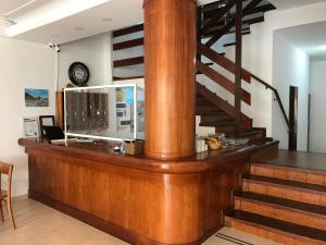 a lobby with a wooden counter and a staircase at Hotel Davinci in San Bernardo