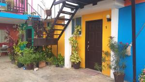 a colorful house with a staircase and a door at Depto Las Puertas la Ria #5 in Campeche