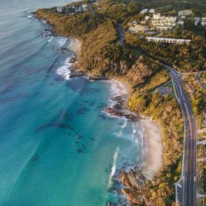 an aerial view of a beach and the ocean at The Point Coolum in Coolum Beach