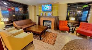 a living room with furniture and a fireplace at Best Western Aspen Hotel in Fort Smith