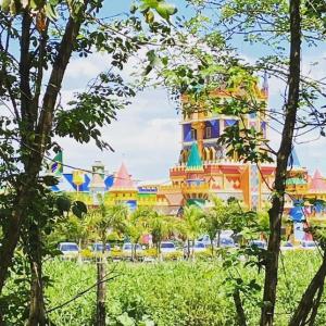 a colorful building with trees in front of it at Pousada Coração do Parque in Penha
