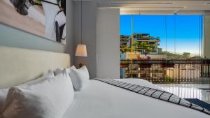 a bedroom with a white bed and a large window at PIER 57 - 709 Stunning View 2 BR Romantic Zone in Puerto Vallarta