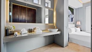 a bathroom with a sink and a bed at PIER 57 - 709 Stunning View 2 BR Romantic Zone in Puerto Vallarta