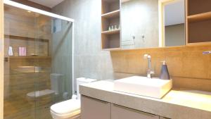 a bathroom with a sink and a toilet and a shower at Barra Bali Apartamento 06 - Paraíso à Beira Mar in Barra de São Miguel