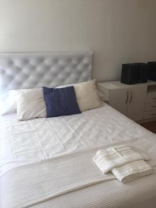 a white bed with two towels on top of it at Miry in Buenos Aires
