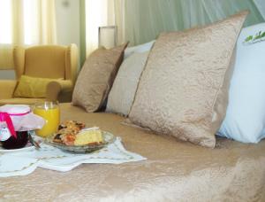 a table with a plate of food on top of a bed at Sparto Village in Meganisi