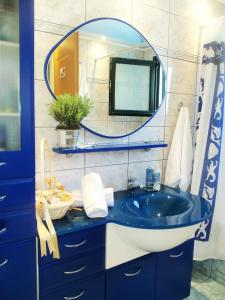 a bathroom with a blue sink and a mirror at Sparto Village in Meganisi