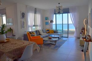 a living room with a couch and a table at Amazing sea View, steps to beach, near Tel-aviv in Bat Yam