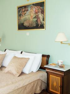 a bedroom with a bed with a painting on the wall at Sparto Village in Meganisi