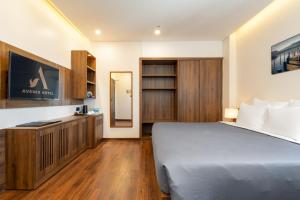 Postel nebo postele na pokoji v ubytování Avenis Hotel
