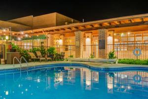 a swimming pool in front of a building at night at Sierra Suites Boutique Hotel in Sierra Vista