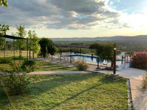 a view of a yard with a swimming pool at Aiken Cabañas in Villa Cura Brochero