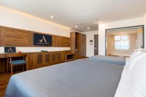 Postel nebo postele na pokoji v ubytování Avenis Hotel