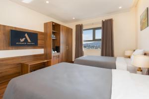 Postel nebo postele na pokoji v ubytování Avenis Hotel