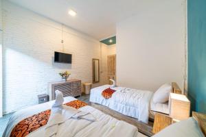 a bedroom with two beds and a fireplace at EUFORIA Guest House in Canggu