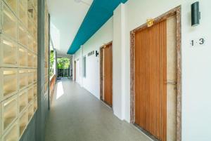 a corridor of a building with a door and a hallway at EUFORIA Guest House in Canggu