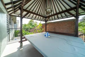 a patio with an umbrella and a table at EUFORIA Guest House in Canggu