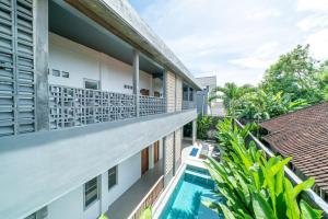 a view of the balcony of a building with a swimming pool at EUFORIA Guest House in Canggu
