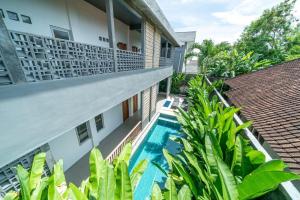 an apartment with a swimming pool in a building at EUFORIA Guest House in Canggu