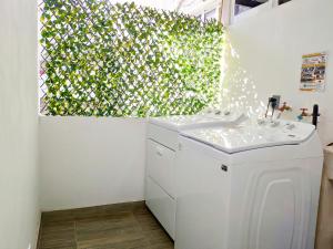 a white laundry room with a green wall at Dep Aurora by Hansa AC Wifi 5 min de playa in Puerto Vallarta +17 photos