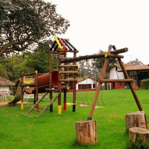 a playground with a slide in a park at Hotel y Centro de Convenciones Pueblito de Yerbabuena Paraíso Natural in Chía