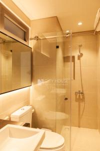 a bathroom with a shower and a toilet and a sink at CityHouse - Kim Nguyên in Ho Chi Minh City