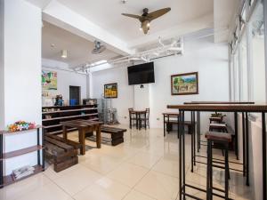 a room with tables and chairs and a ceiling fan at Sulit Budget Hotel VMapa in Manila