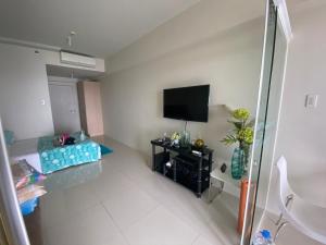 a room with a flat screen tv on a wall at Elize Wind Residences in Tagaytay