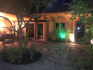 a house with a lit up patio at night at Monikas Ferienwohnung in Stiefenhofen