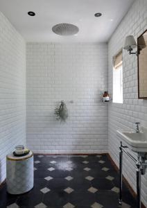 a white bathroom with a sink and a toilet at La Clé Lodge in Franschhoek