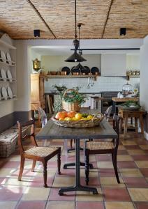 a kitchen with a table with a bowl of fruit on it at La Clé Lodge in Franschhoek