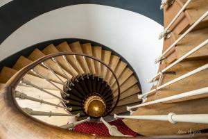 a spiral staircase in a building at Élysée Hôtel in Châteauroux