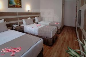 A bed or beds in a room at Sembol Hotel