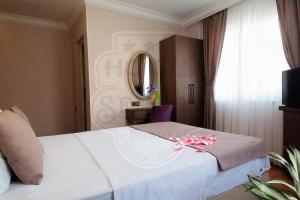 A bed or beds in a room at Sembol Hotel