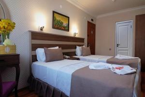 A bed or beds in a room at Sembol Hotel