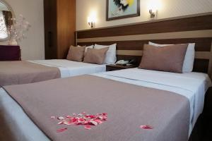 A bed or beds in a room at Sembol Hotel