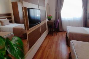 A bed or beds in a room at Sembol Hotel