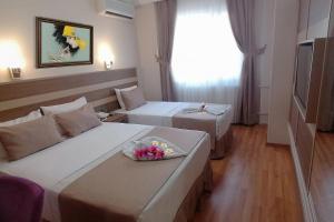 A bed or beds in a room at Sembol Hotel