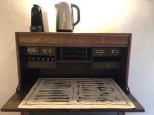 a wooden table with a coffee maker and a kettle on it at Palazzo Romanelli B&B in Trani