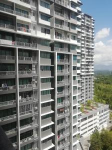 a tall white apartment building with balconies on it at FZ Almyra Homestay in Kajang