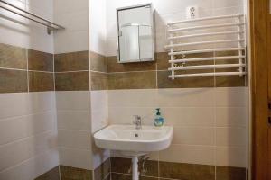 a bathroom with a sink and a mirror at Éva Vendégház in Kaposvár