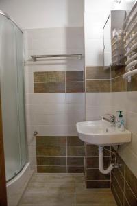 a bathroom with a sink and a shower at Éva Vendégház in Kaposvár