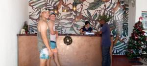 a group of men standing around a counter with a christmas tree at Fawlty Towers Accommodation & Activities in Livingstone