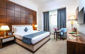 カイロにあるトリプ ゴールデン プラザのベッドとデスクが備わるホテルルームです。