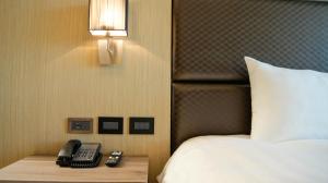 Postel nebo postele na pokoji v ubytování Kuei Ti Wan Hotel