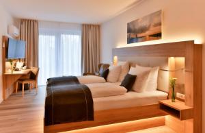 TV a/nebo společenská místnost v ubytování Four Stars by City Hotel