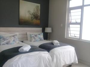 a bedroom with two beds with towels on them at Beechwood B&B in Durban