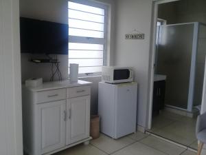 a kitchen with a microwave on top of a refrigerator at Beechwood B&B in Durban