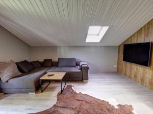 a living room with a couch and a tv at Ferienwohnung Annelies - Chiemgau Karte in Inzell